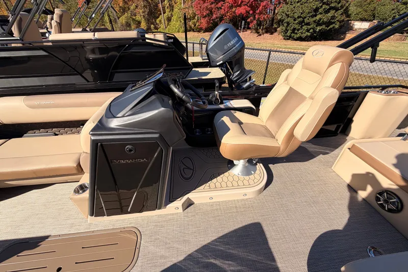 Slide: The Image of 2026 Veranda VR235VL pontoon boat interior with beige seating and steering console. - 7