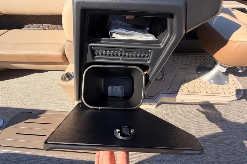 Slide: The Image of 2026 Veranda VR235VL boat interior with open storage compartment and beige seating. - 8