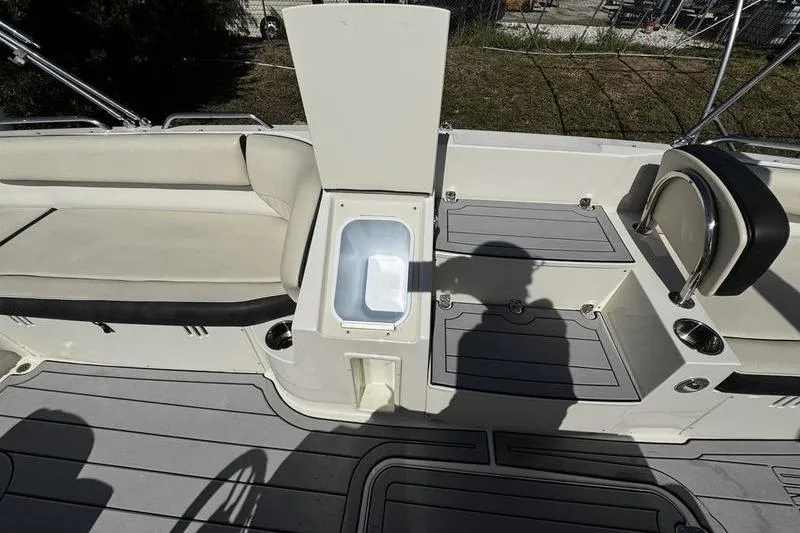 Slide: The Image of 2022 Stingray 212SC boat interior with seating and storage compartments. - 12