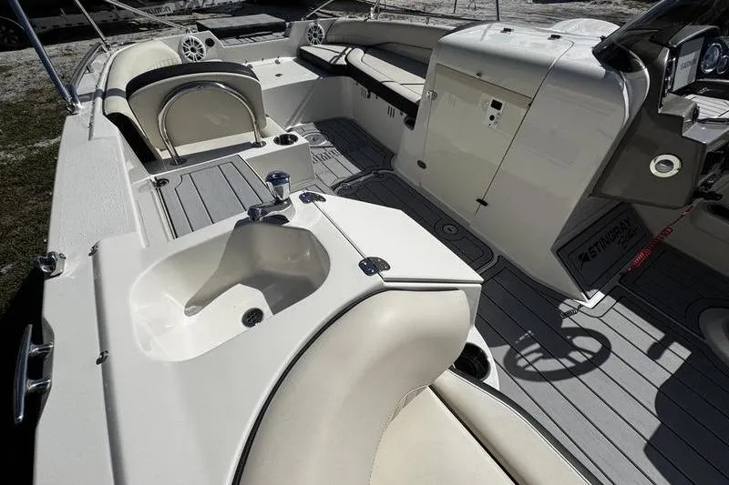 Slide: The Image of 2022 Stingray 212SC boat interior with seating, sink, and control panel. - 13