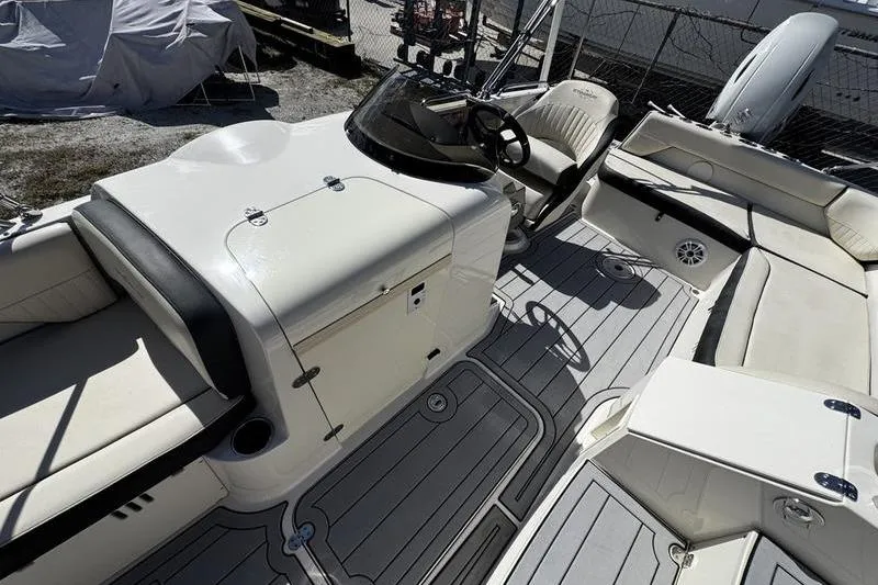 Slide: The Image of 2022 Stingray 212SC boat interior with seating and steering console. - 14