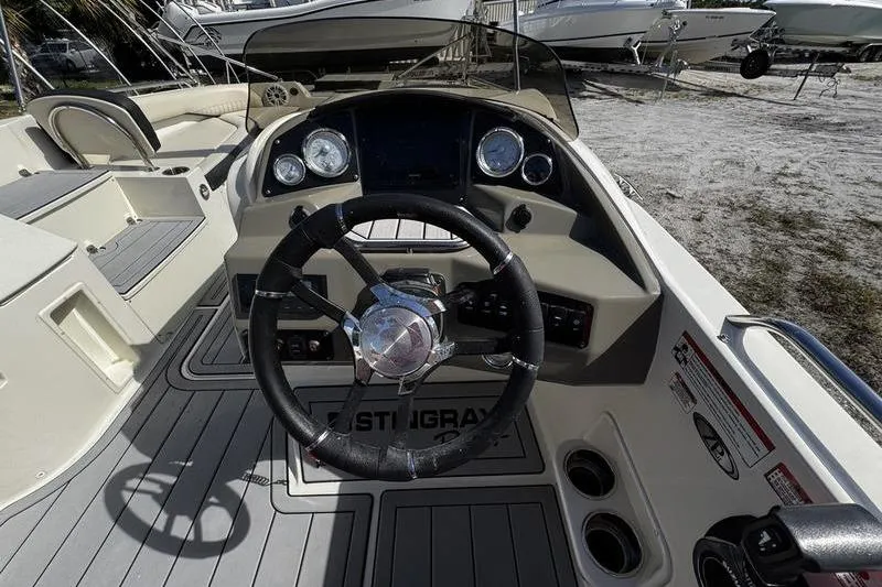 Slide: The Image of 2022 Stingray 212SC boat dashboard with steering wheel and gauges. - 17