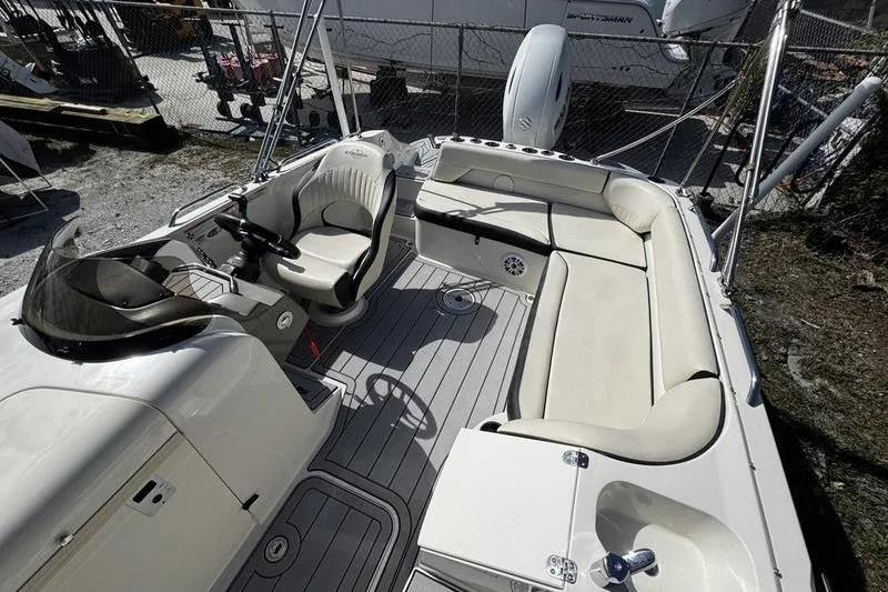 Slide: The Image of 2022 Stingray 212SC boat interior with seating and steering console. - 21