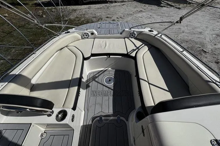 Slide: The Image of 2022 Stingray 212SC boat interior with cushioned seating and sleek design. - 9