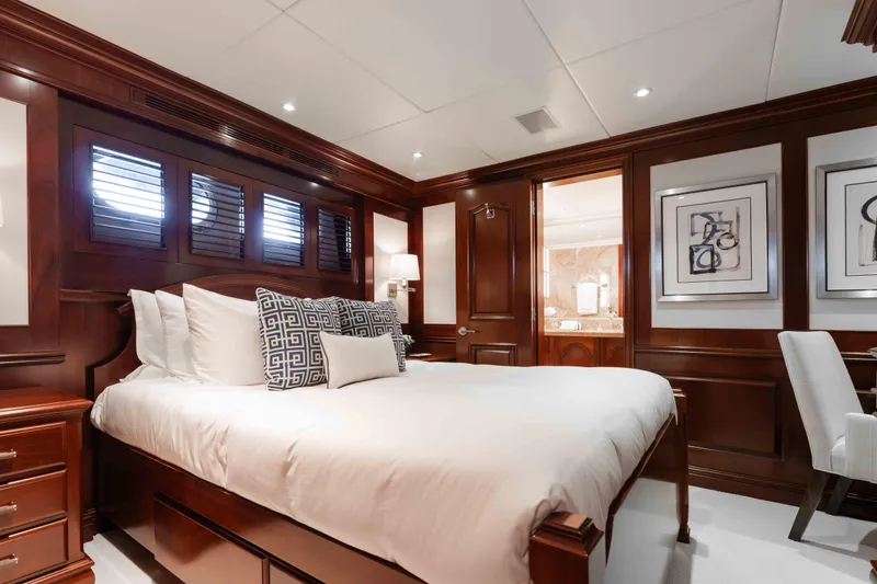 Slide: The Image of Luxurious bedroom interior on 2004 Trinity Yachts motor yacht, featuring elegant wood paneling. - 18