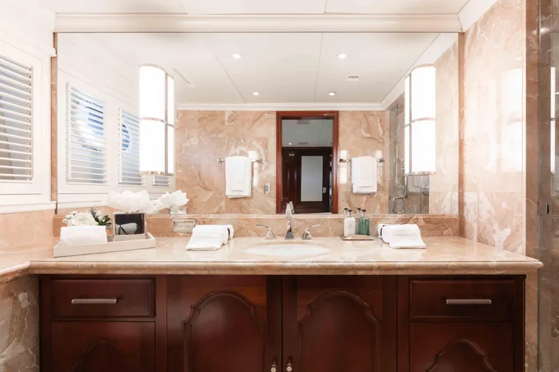 Slide: The Image of Luxurious marble bathroom on 2004 Trinity Yachts motor yacht, featuring elegant wooden cabinetry. - 19