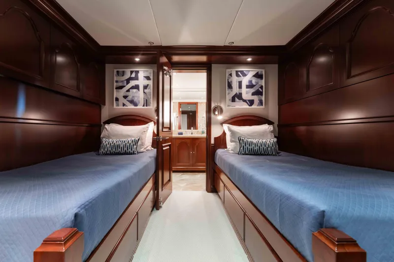 Slide: The Image of Luxurious twin cabin with wooden paneling on 2004 Trinity Yachts motor yacht. - 20