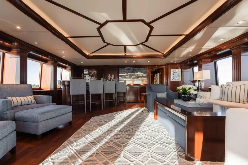 Slide: The Image of Luxurious interior of 2004 Trinity Yachts motor yacht with elegant seating and wooden accents. - 22