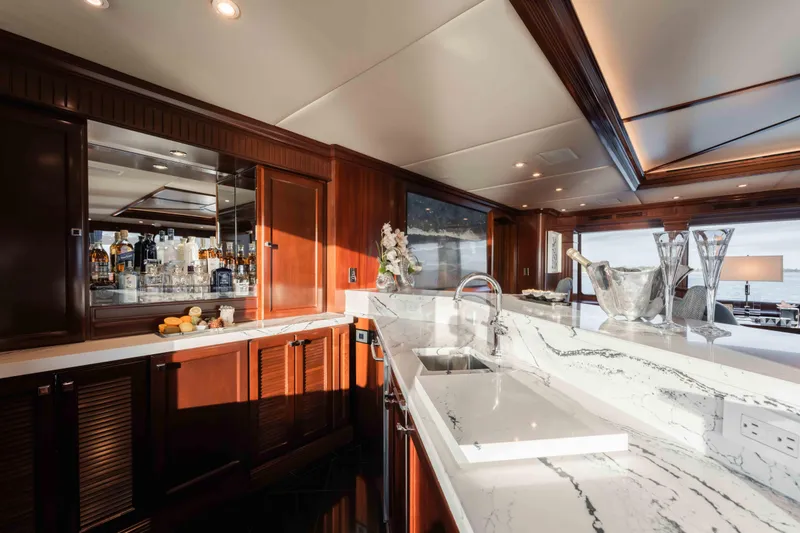 Slide: The Image of Luxurious interior of 2004 Trinity Yachts motor yacht with elegant bar and marble countertops. - 24