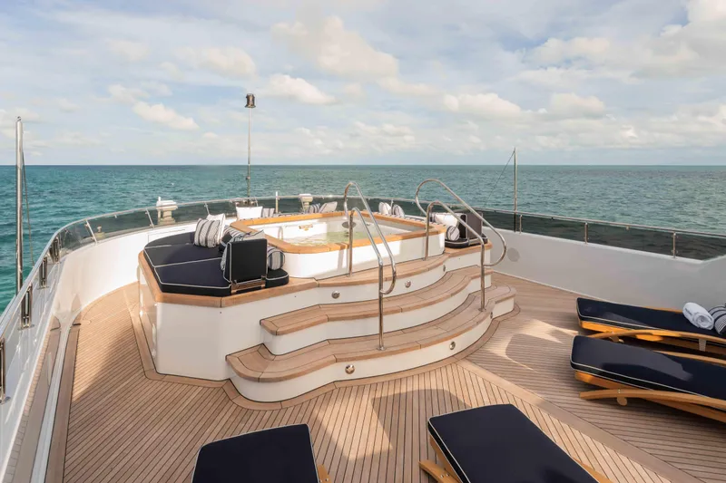 Slide: The Image of Luxurious 2004 Trinity Yachts motor yacht deck with jacuzzi and sun loungers. - 27