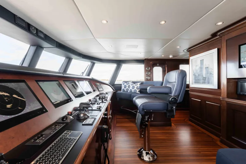 Slide: The Image of Luxurious 2004 Trinity Yachts motor yacht helm with advanced navigation systems and plush seating. - 33