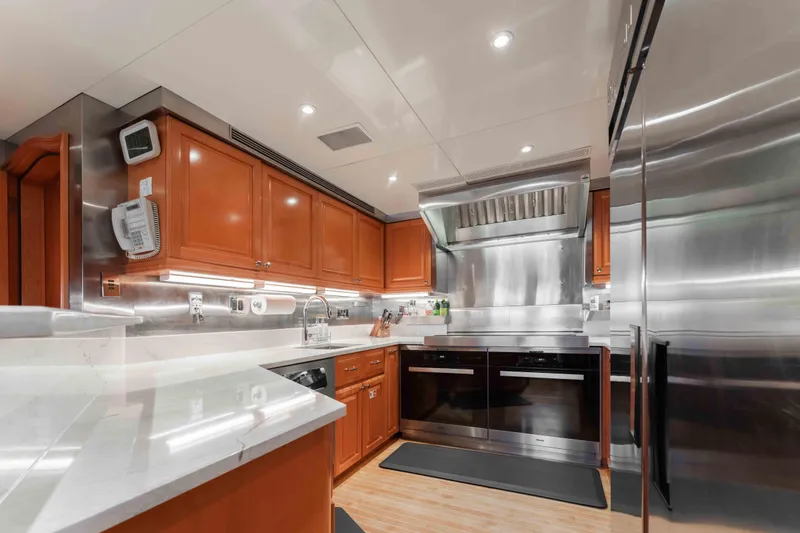 Slide: The Image of Luxurious kitchen in 2004 Trinity Yachts motor yacht with modern appliances and wooden cabinetry. - 35