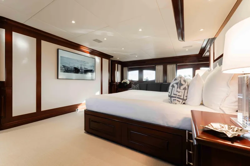 Slide: The Image of Luxurious bedroom interior of 2004 Trinity Yachts motor yacht with elegant wood paneling. - 9