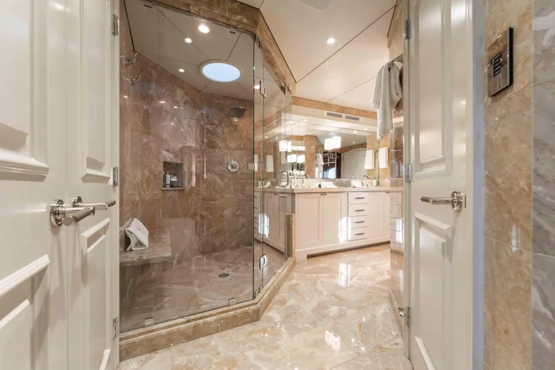Slide: The Image of Luxurious marble bathroom on 2004 Trinity Yachts motor yacht, featuring glass shower and elegant fixtures. - 11