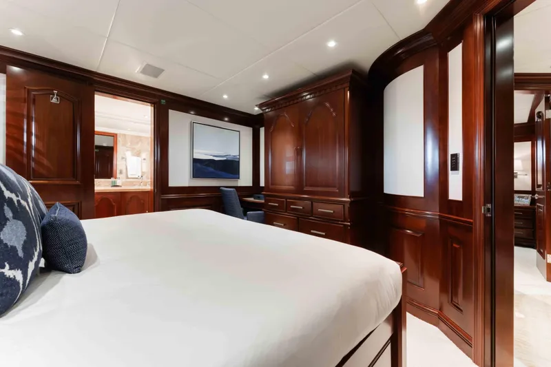 Slide: The Image of Luxurious 2004 Trinity Yachts motor yacht bedroom with elegant wood paneling and modern decor. - 14