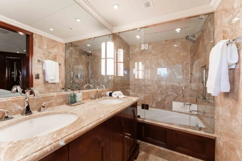Slide: The Image of Luxurious marble bathroom in 2004 Trinity Yachts motor yacht, featuring dual sinks and glass shower. - 15