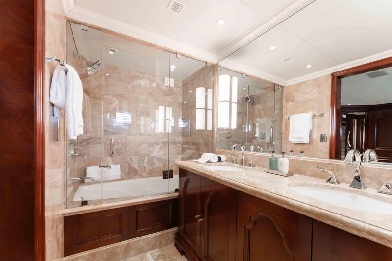 Slide: The Image of Luxurious bathroom in 2004 Trinity Yachts motor yacht with marble finishes and dual sinks. - 17