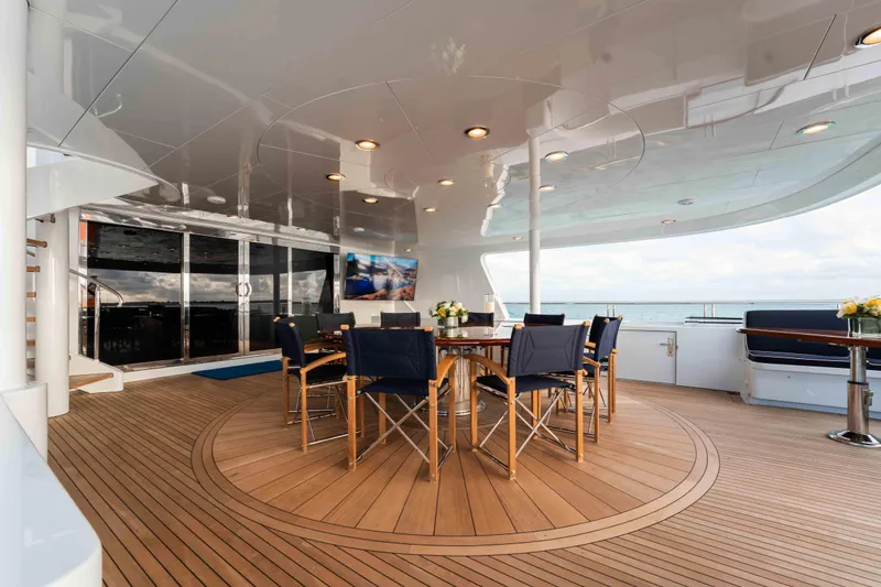 Slide: The Image of Luxurious 2004 Trinity Yachts motor yacht deck with elegant outdoor dining area. - 25