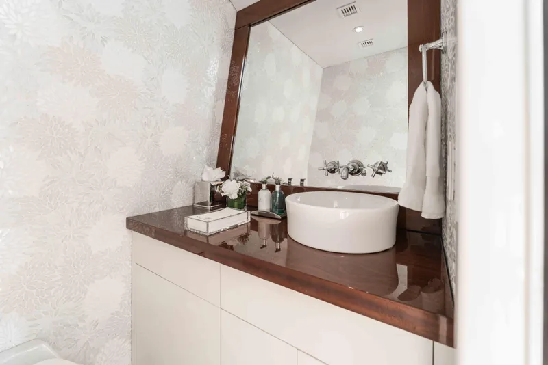 Slide: The Image of Luxurious bathroom on 2004 Trinity Yachts motor yacht with elegant sink and floral wallpaper. - 30
