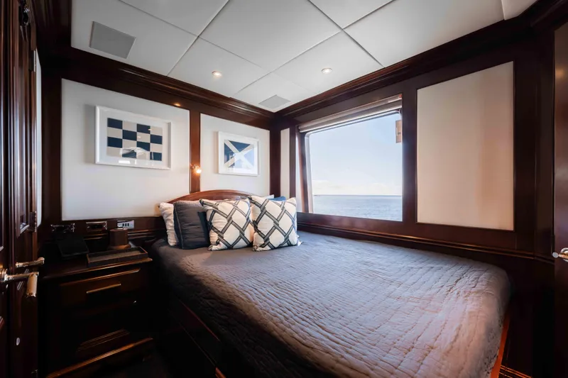 Slide: The Image of Luxurious 2004 Trinity Yachts motor yacht bedroom with ocean view and elegant decor. - 38