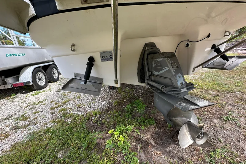 Slide: The Image of Rear view of a 2006 Regal Commodore 2665 boat with visible propeller and trim tabs. - 19