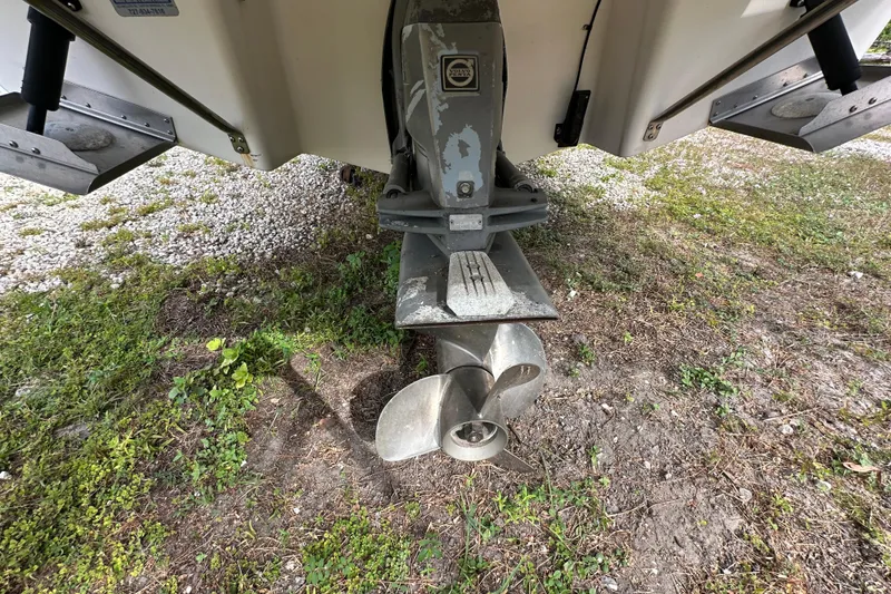 Slide: The Image of 2006 Regal Commodore 2665 boat propeller and stern drive on grassy ground. - 20
