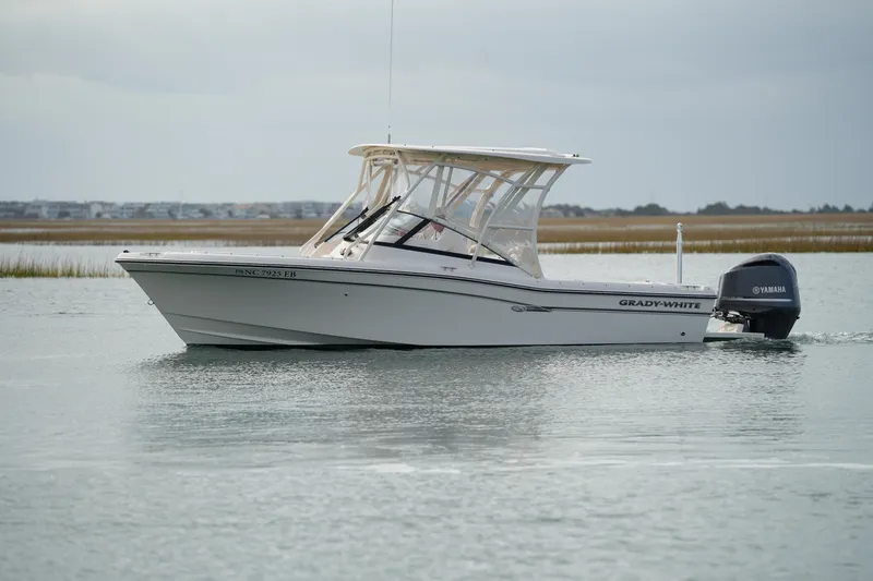 The Image of 2016 Grady-White Freedom 225 boat on calm water with Yamaha outboard motor. - 0