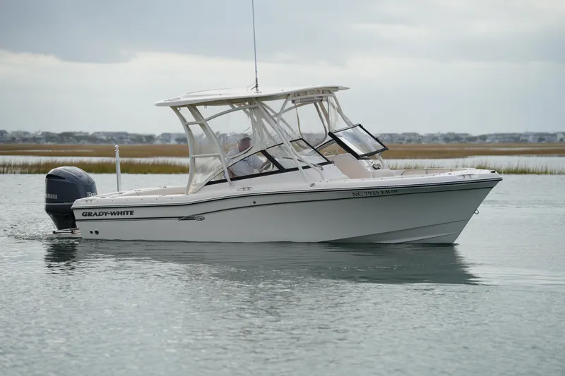 Slide: The Image of 2016 Grady-White Freedom 225 boat on calm water, side view. - 10
