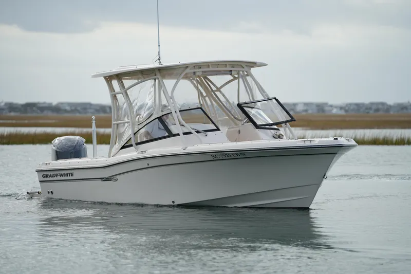 Slide: The Image of 2016 Grady-White Freedom 225 boat cruising on calm water. - 11