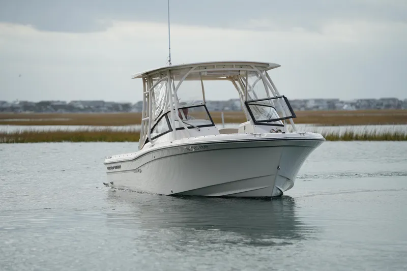 Slide: The Image of 2016 Grady-White Freedom 225 boat on calm water, overcast sky in background. - 12