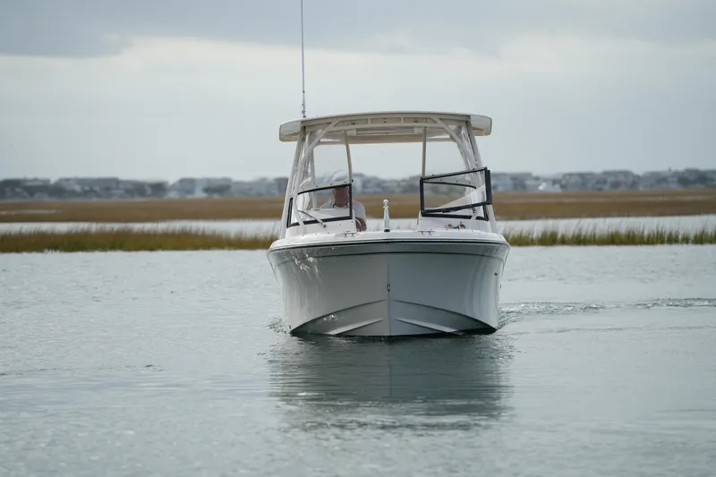 Slide: The Image of 2016 Grady-White Freedom 225 boat cruising on calm water. - 13