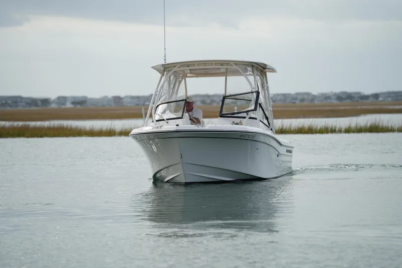 Slide: The Image of 2016 Grady-White Freedom 225 boat cruising on calm water. - 14