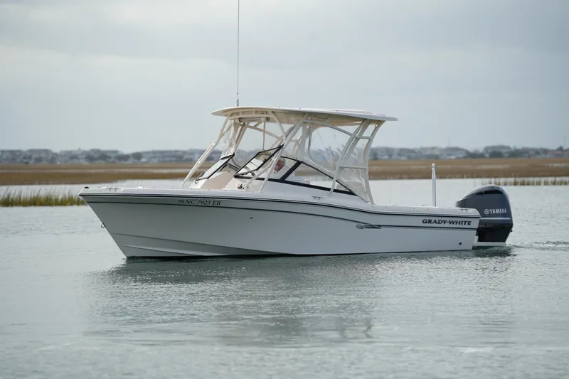 Slide: The Image of 2016 Grady-White Freedom 225 boat on calm water with Yamaha engine. - 16