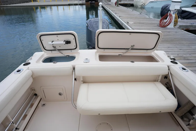 Slide: The Image of 2016 Grady-White Freedom 225 boat interior with open storage compartments at dock. - 18