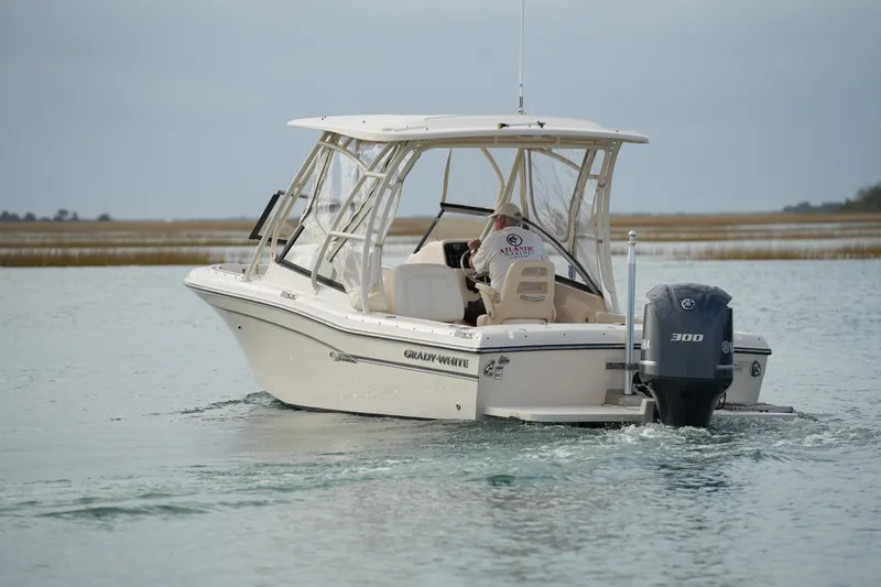 Slide: The Image of 2016 Grady-White Freedom 225 boat cruising on calm waters. - 2