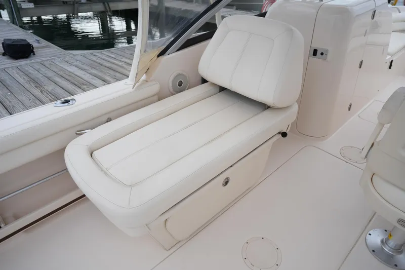 Slide: The Image of 2016 Grady-White Freedom 225 boat interior with white cushioned seating. - 20