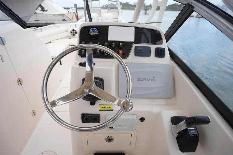 Slide: The Image of 2016 Grady-White Freedom 225 boat helm with Garmin navigation system and Yamaha controls. - 22
