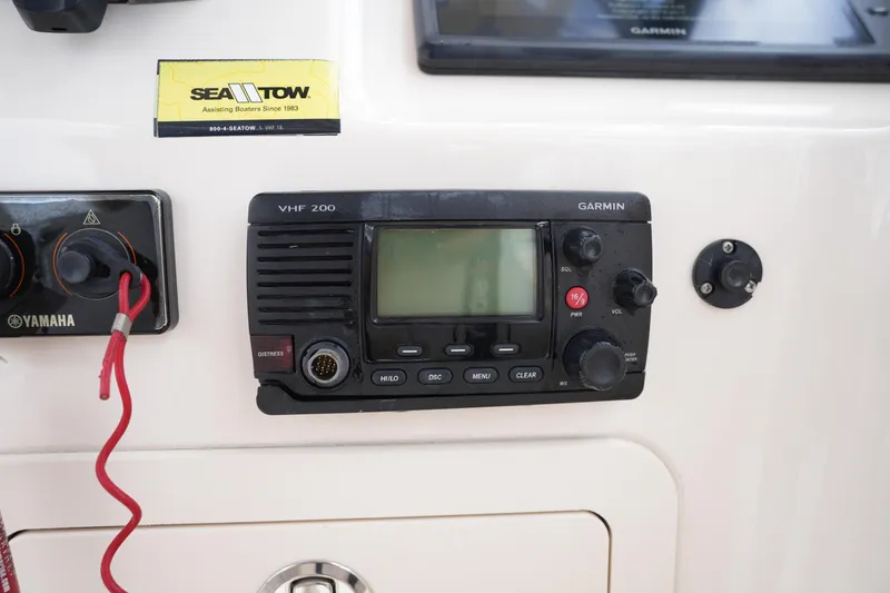Slide: The Image of Control panel of a 2016 Grady-White Freedom 225 with Garmin VHF 200 radio. - 27