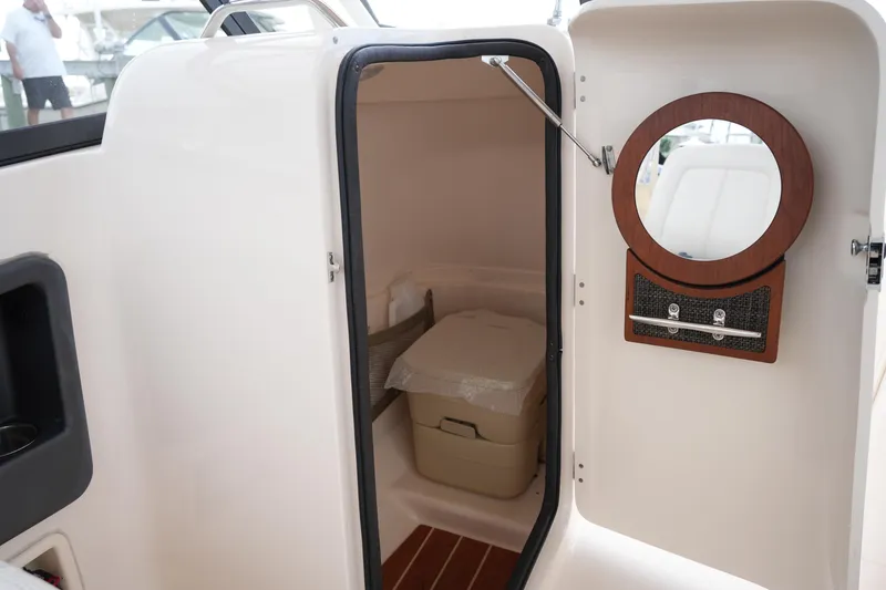Slide: The Image of 2016 Grady-White Freedom 225 boat interior with storage compartment and mirror. - 29