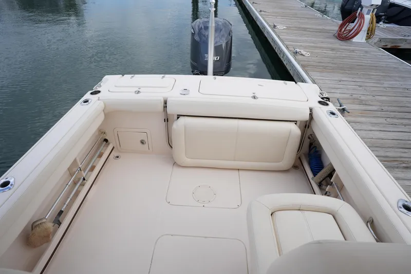 Slide: The Image of 2016 Grady-White Freedom 225 boat interior at dock, featuring spacious seating and storage. - 34