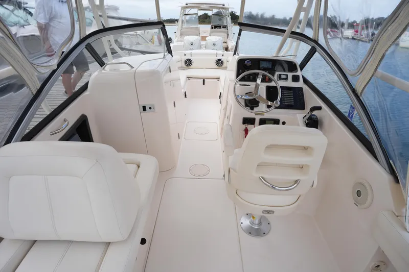 Slide: The Image of 2016 Grady-White Freedom 225 boat interior with steering wheel and seating. - 35