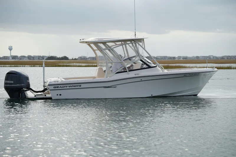Slide: The Image of 2016 Grady-White Freedom 225 boat on calm water with Yamaha outboard motor. - 9
