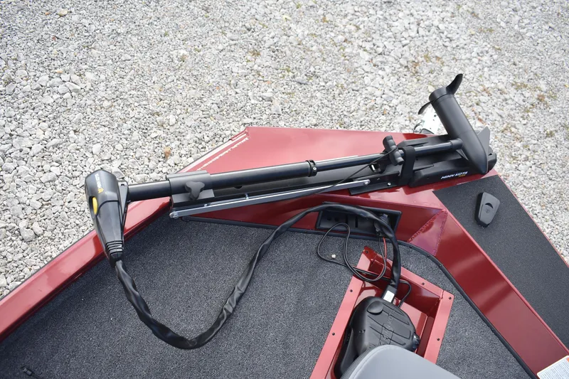 Slide: The Image of 2026 Lowe Stinger 175C boat with Minn Kota trolling motor on gravel. - 14