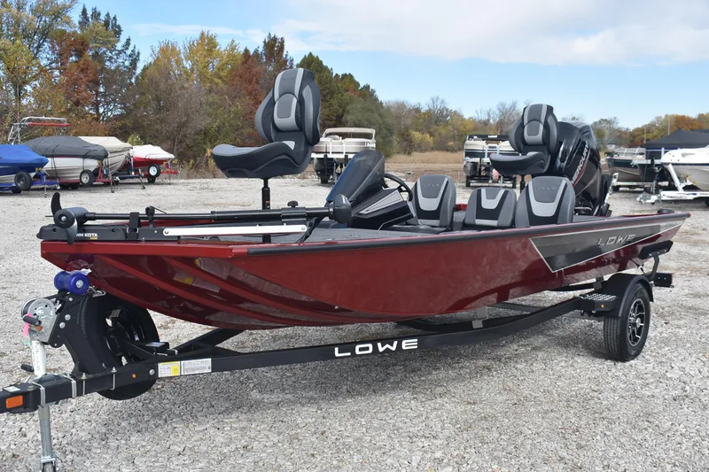 Slide: The Image of 2026 Lowe Stinger 175C fishing boat on trailer, parked outdoors. - 2