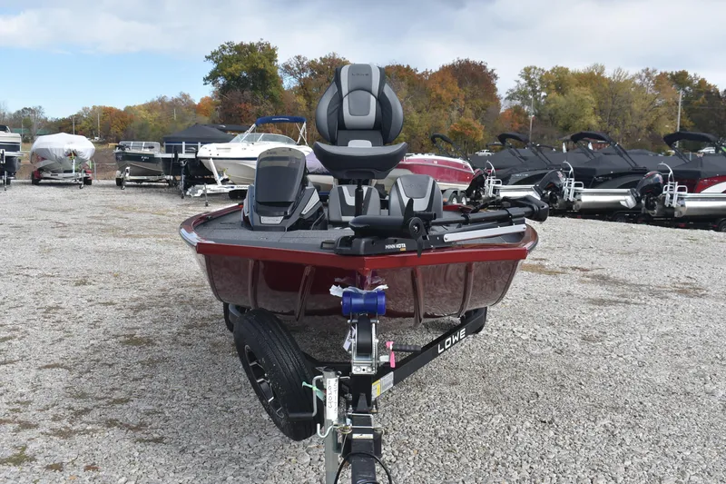 Slide: The Image of 2026 Lowe Stinger 175C boat on trailer, surrounded by other boats, autumn trees in background. - 3