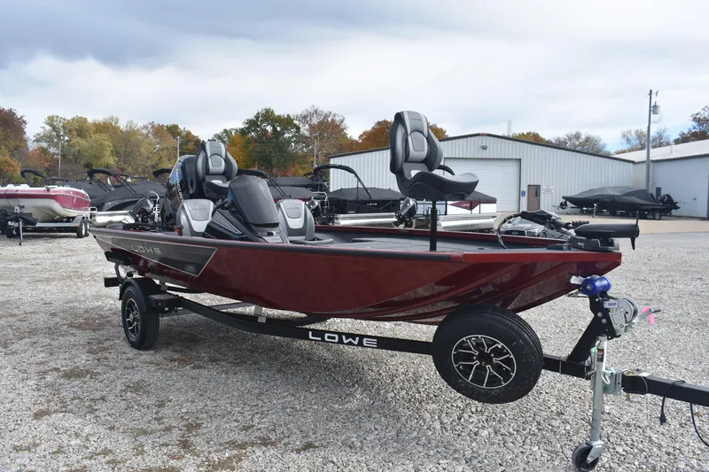Slide: The Image of 2026 Lowe Stinger 175C fishing boat on trailer, parked outdoors. - 4