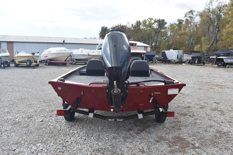 Slide: The Image of 2026 Lowe Stinger 175C boat on trailer in outdoor storage area. - 6