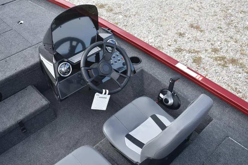 Slide: The Image of 2026 Lowe Stinger 175C boat interior with steering wheel and control panel. - 9