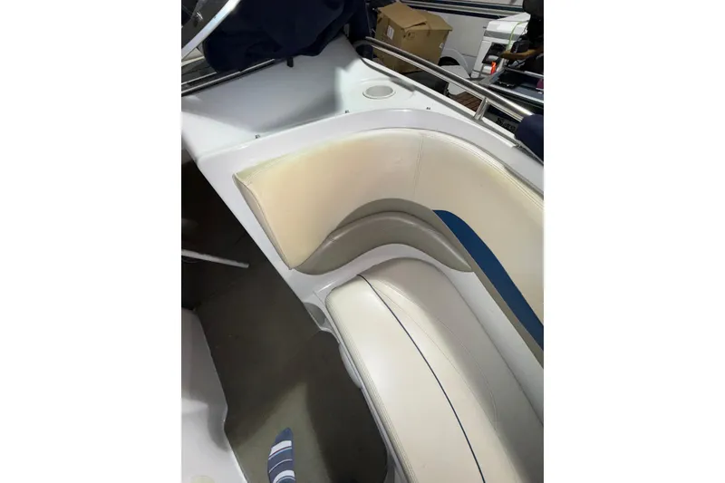 Slide: The Image of 1999 Four Winns 220 Horizon boat interior with white and blue seating. - 16