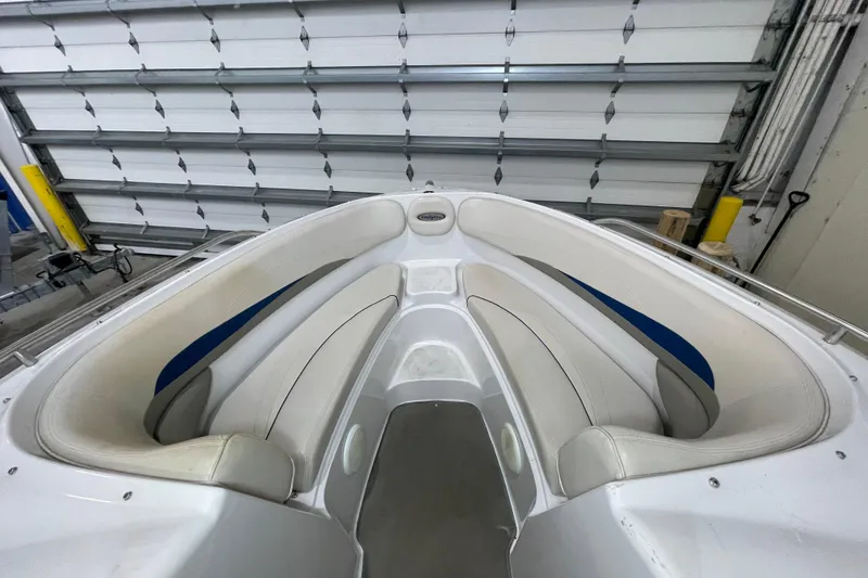 Slide: The Image of Interior view of a 1999 Four Winns 220 Horizon boat with white seating. - 18